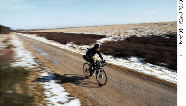 a person riding a bike on a dirt road